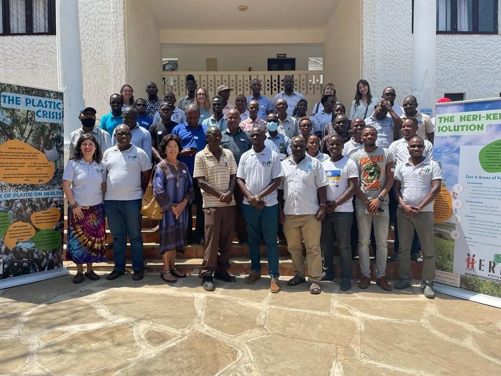 Participants and partners gather outside a HERI-Kenya event in 2022